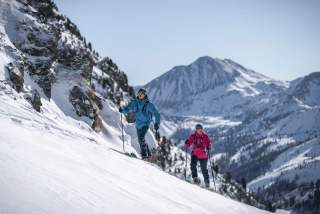 Zwei Personen auf Skitour an einem verschneiten Berghang.